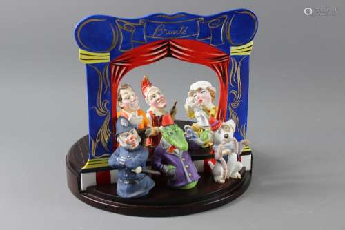 A Bronte Extinguishers Limited Edition Punch and Judy Theatre, complete with the players, the whole supported on an circular oak base