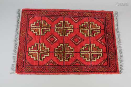 An Afghan Tribal Prayer Rug; the rug in claret and gold colours; approx 60 x 60 cms