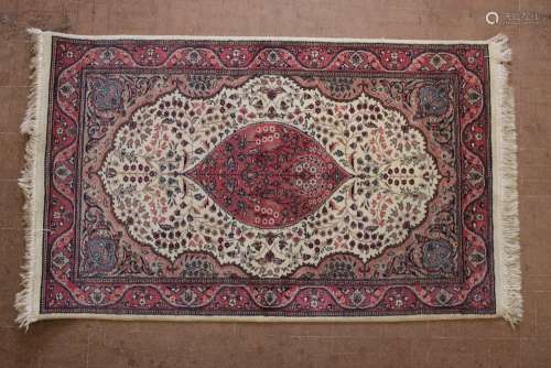 A Pink and Beige Wool Rug; the rug having a central medallion in pink surrounded by beige and light brown with a pink border, approx 94 x 155 cms