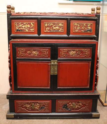 A Chinese Hardwood Red Painted Chest; with gilded decoration to panels and top, depicting flowers, cupboard set on a platform with two drawers, approx 90 x 60 x 104 cms
