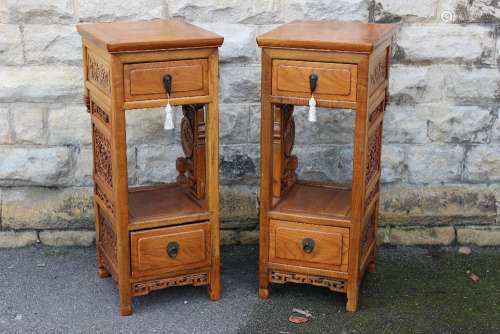 Two Chinese Hardwood Torchere; each cabinet having a single drawer, decorative carvings to skirt and shelf, straight feet, approx 46 x 40 x 97 cms