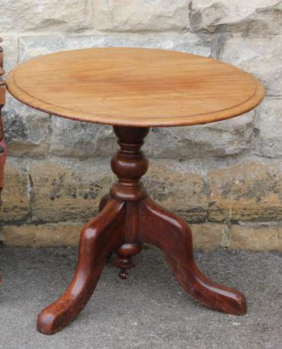 A Circular Tilt-Top Mahogany Occasional Table; the table measures approx 58 h x 63 diameter, carved column on tripod base