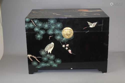A Chinese Black Lacquer Travelling Trunk; the trunk decorated with stork birds and pine branches, handles to sides, approx 66 x 45 x 48 cms, together with a vintage oriental torchere approx 131 cms h also decorated to stem and base