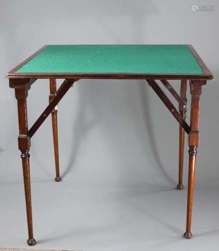 An Edwardian Folding Bridge Table; the table having green baize, approx 71 x 71 x 70 cms