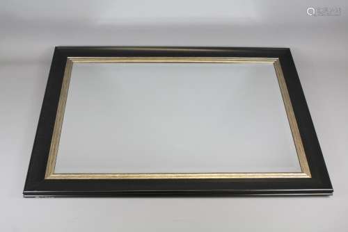 Contemporary Rectangular Mirror; the bevelled mirror set in a black and gilt frame, the mirror approx 50 x 75 cms