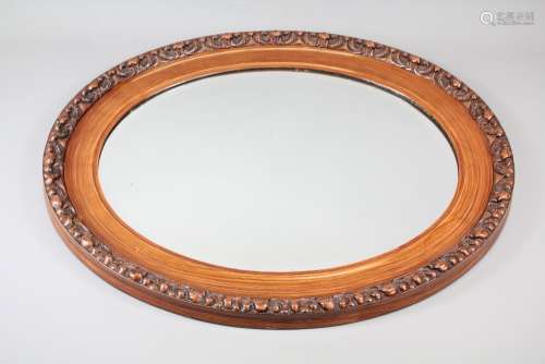 An Oval Hall Mirror; the mirror having foliate decoration to the frame, approx 63 x 52 cms