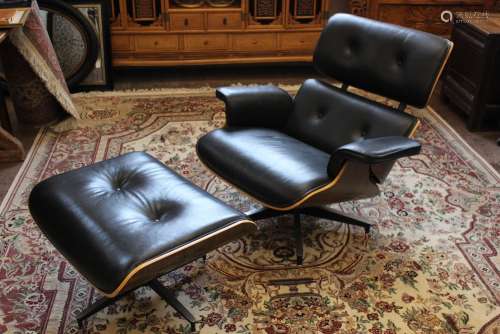 A Black Leather Eames-style Recliner Chair and Ottoman