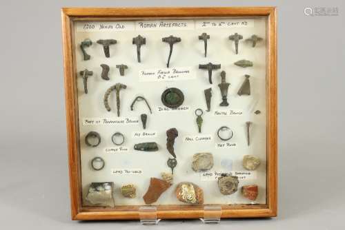 Archaeological Finds - Roman Era, including brooches, painted terracotta, copper rings, nails all mounted in a perspex case