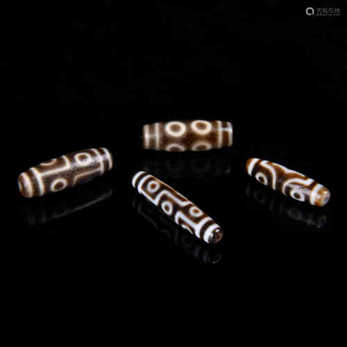 A Group of Four Carved Agate DZI Bead