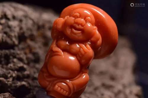 A Chinese Carved Coral Figure of Buddha