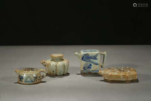 GROUP OF FOUR MINIATURE BLUE AND WHITE EWERS