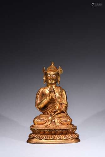 A GILT-BRONZE FIGURE OF GURU