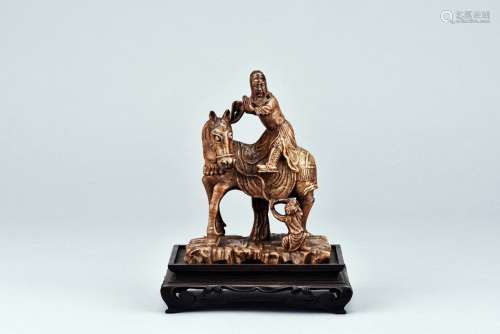 A STONE CARVING OF GUAN YU ON HORSE