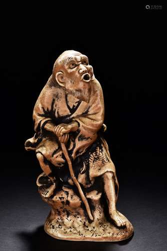 A SHIWAN POTTERY FIGURE