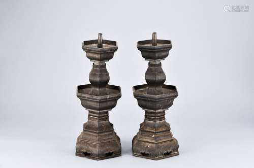 A PAIR OF BRONZE CANDLESTICKS