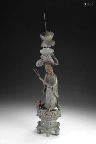 A CHINESE TAOIST FIGURE PEWTER CANDLESTICK HOLDER