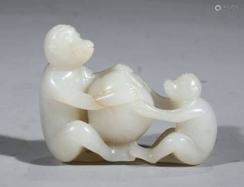 A WHITE JADE 'MONKEY AND PEACH' CARVING