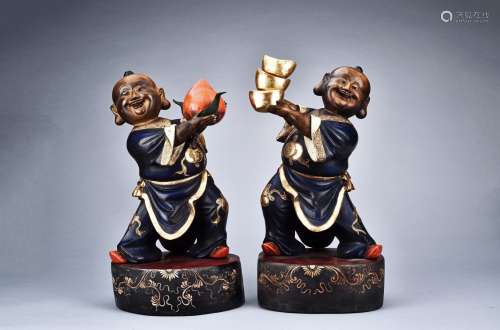 A PAIR OF LACQUERED WOODEN CARVED BOY FIGURES