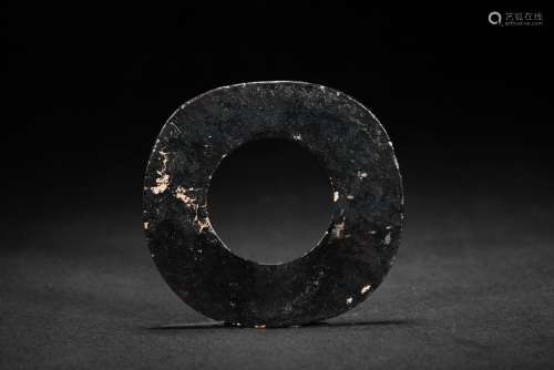 AN OPAQUE BLACK JADE CARVED DISC