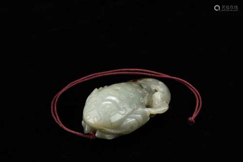 A CELADON JADE CARVED 'FISH' PENDANT