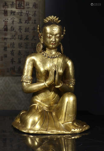 copper and gold sitting Buddha