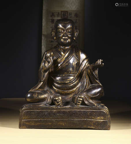 copper and gold sitting Buddha