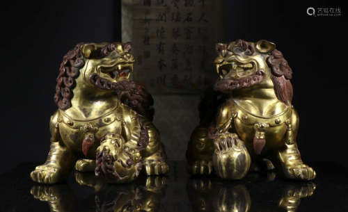 a pair pf copper and gold lion ornaments