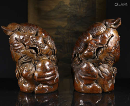 a pair of bamboo beast carvings