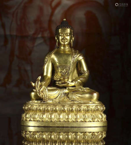 copper and gold sitting Buddha