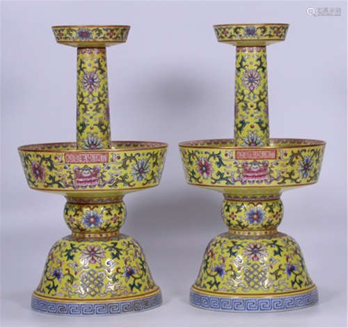 A PAIR OF YELLOW UNDER GLAZE FAMILLE ROSE FLOWER CANDLE HOLDERS