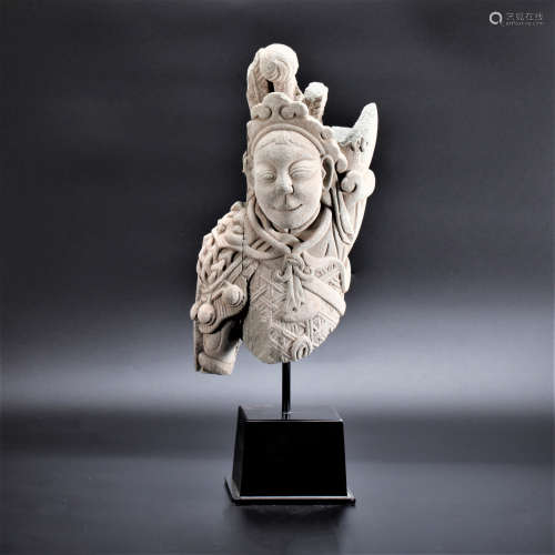 A STONE CARVED FIGURE