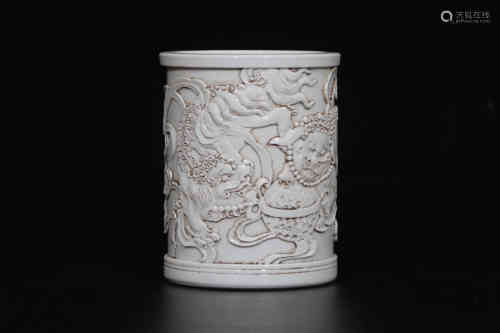 A Chinese White Glazed Carved Porcelain Brush Pot
