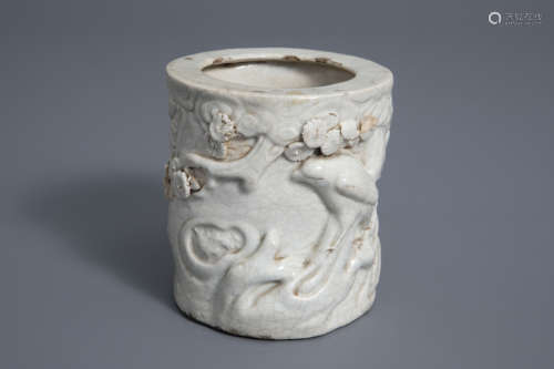 A Chinese monochrome crackle glazed relief decorated brush pot, 19th C.