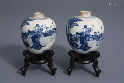 A pair of Chinese blue and white jars with figures in a garden, Kangxi mark, 19th/20th C.