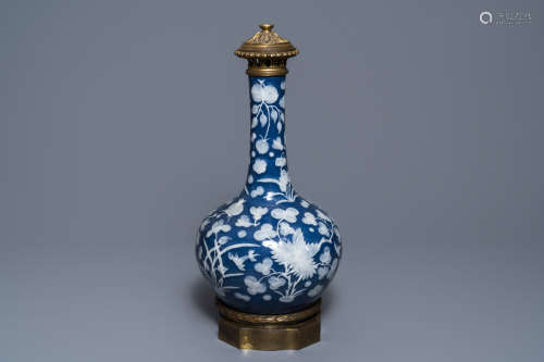 A Chinese blue ground slip decorated bronze mounted bottle vase, 19th C.