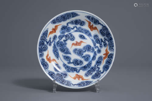 A Chinese blue, white and iron red 'bats and clouds' plate, 19th/20th C.