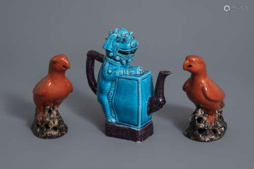 A Chinese turquoise and aubergine glazed Buddhist lion shaped teapot and a pair of red glazed parrots, 20th C.