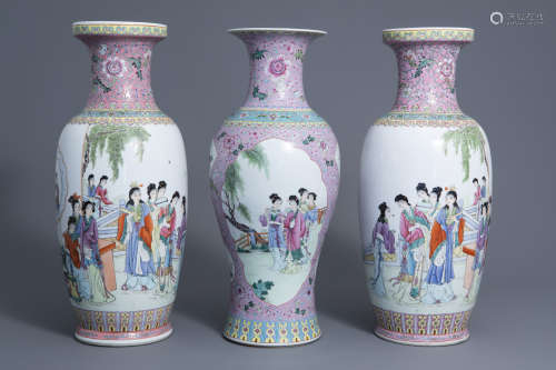 A pair of Chinese famille rose vases and a baluster vase with ladies in a garden, 20th C.