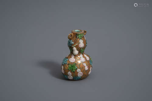 A Chinese famille rose relief decorated gourd shaped snuff bottle, Qianlong mark, 19th/20th C.