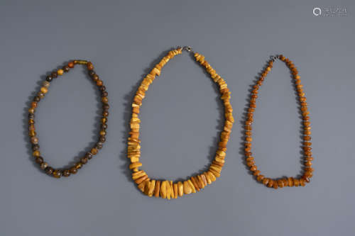 Three Chinese amber necklaces, including butterscotch, 19th/20th C.