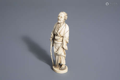 A Japanese carved ivory figure of an elder, Meiji, 19th C.