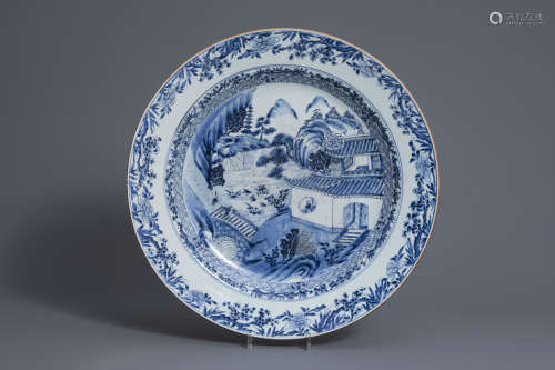 A large Chinese blue and white charger with figures in a landscape, Qianlong