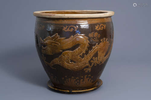 A large Chinese brown glazed stoneware jardinière on stand with a dragon, 19th/20th C.