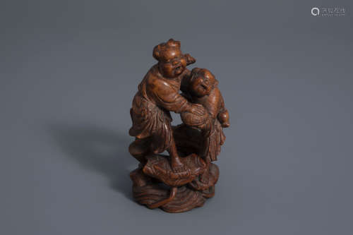 A Chinese carved bamboo group of two boys making merry, 19th C.