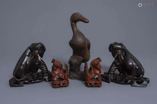 A Chinese Shiwan pottery model of a duck and two pairs of carved wood models of elephants and Buddhist lions, 19th/20th C. and Republic