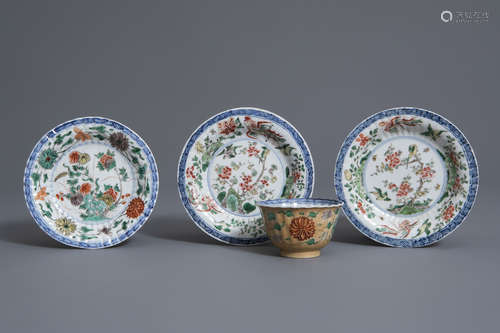 A Chinese famille verte light brown ground cup and saucer and a pair of saucers, Kangxi