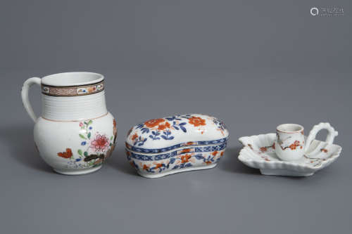 A Chinese Imari style box and cover, a famille rose mug and a candlestick, Kangxi and later