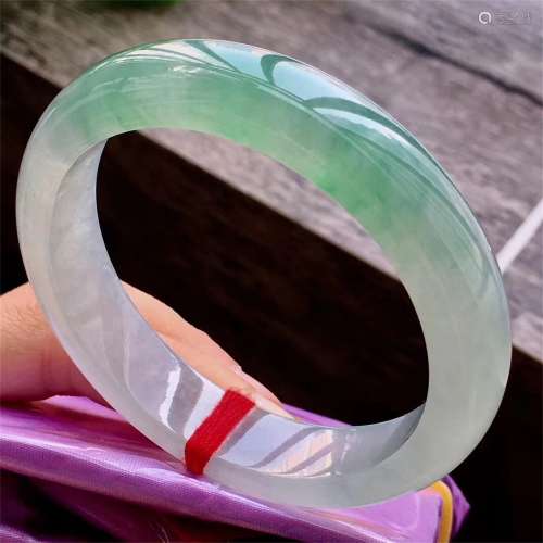 A Chinese Carved Jadeite Bracelet