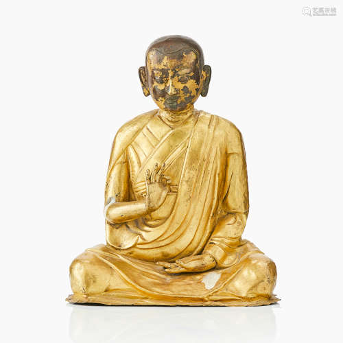 30. A Tibetan gilt copper figure of a Luohan