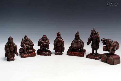 Seven Japanese carved wood figures.